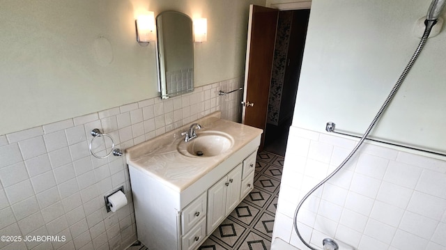 bathroom featuring vanity, tile walls, a wainscoted wall, and tile patterned floors