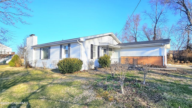 view of front of home with a front lawn and a chimney