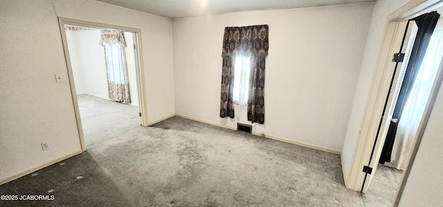 carpeted spare room with baseboards