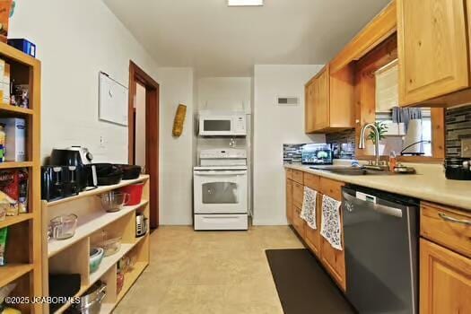 409 E 9th St, Fulton, MO 65251 - kitchen with white appliances, light countertops, and light flooring
