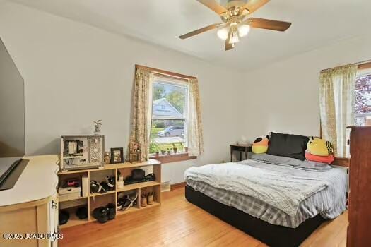 409 E 9th St, Fulton, MO 65251 - bedroom featuring multiple windows, wood finished floors, and a ceiling fan