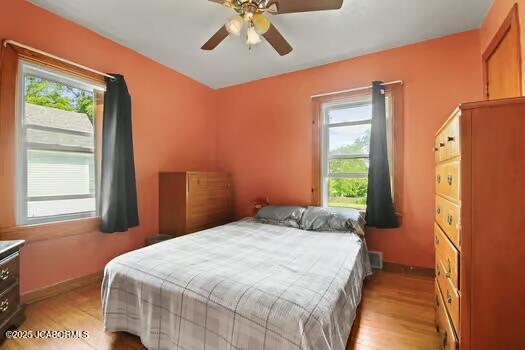 409 E 9th St, Fulton, MO 65251 - bedroom with light wood finished floors and ceiling fan