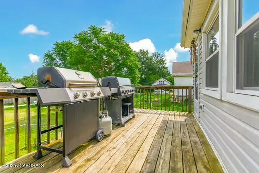 409 E 9th St, Fulton, MO 65251 - wooden terrace featuring grilling area and a lawn