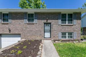 1628 Starlite Dr, Jefferson City, MO 65109 - bi-level home with an attached garage and brick siding