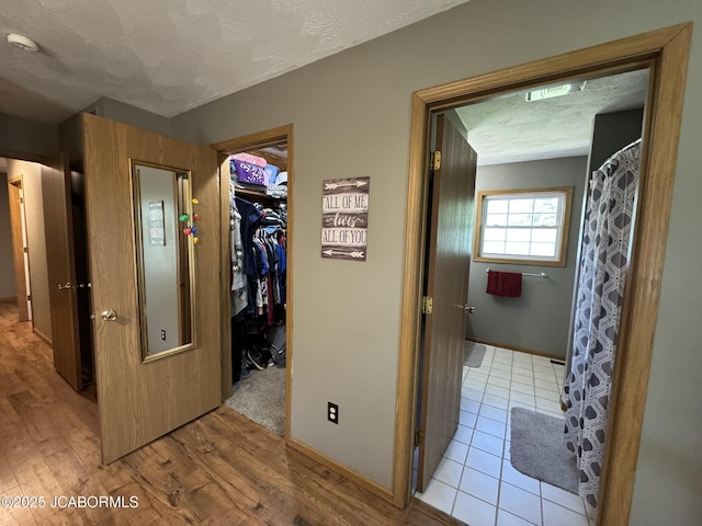 128 Don Dr, Linn, MO 65051 - hallway featuring a textured ceiling and light wood finished floors