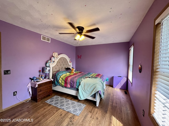 128 Don Dr, Linn, MO 65051 - bedroom with multiple windows, wood finished floors, and a ceiling fan
