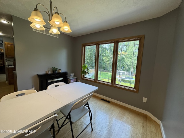 128 Don Dr, Linn, MO 65051 - office area with a chandelier and wood finished floors