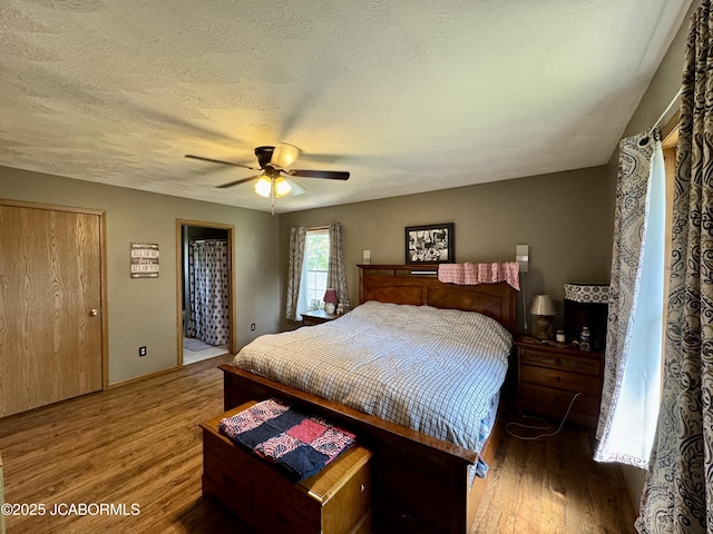 128 Don Dr, Linn, MO 65051 - bedroom featuring wood finished floors, a textured ceiling, and ceiling fan