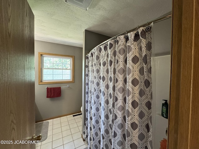 128 Don Dr, Linn, MO 65051 - bathroom featuring a textured ceiling, tile patterned flooring, and a shower with shower curtain