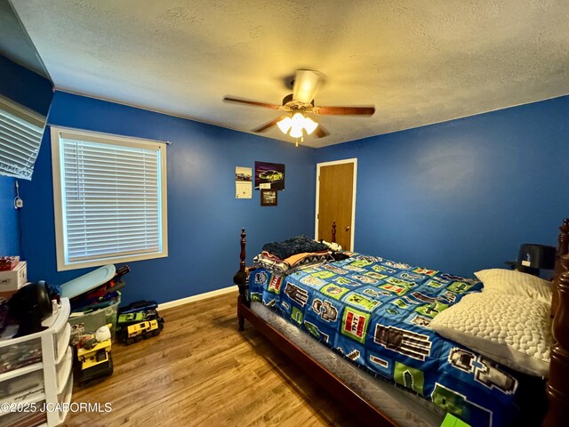 128 Don Dr, Linn, MO 65051 - bedroom with a textured ceiling, wood finished floors, and ceiling fan