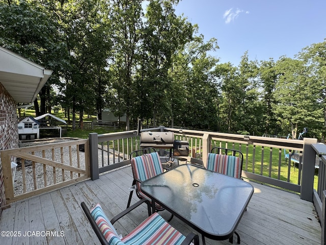 128 Don Dr, Linn, MO 65051 - wooden terrace with outdoor dining area and a lawn