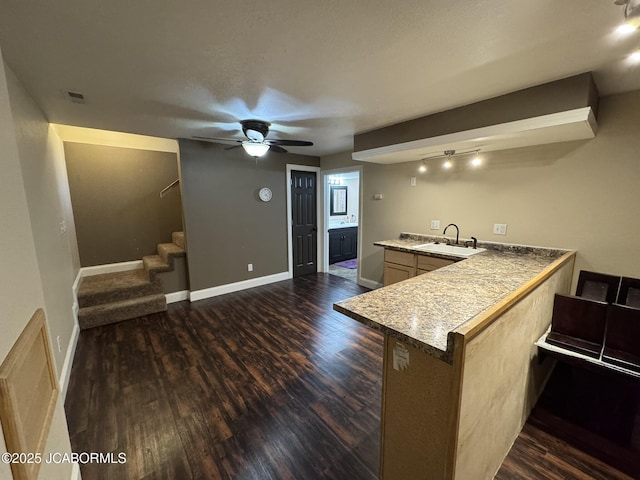 128 Don Dr, Linn, MO 65051 - kitchen featuring a peninsula, dark wood-style flooring, ceiling fan, and a breakfast bar