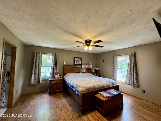 128 Don Dr, Linn, MO 65051 - bedroom with a textured ceiling, wood finished floors, and a ceiling fan