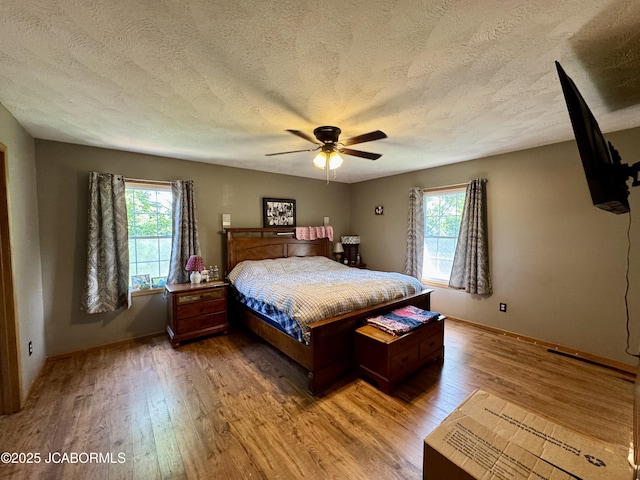128 Don Dr, Linn, MO 65051 - bedroom featuring light wood finished floors, a textured ceiling, and a ceiling fan