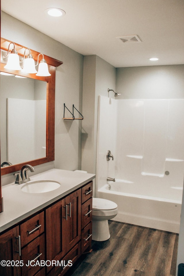 138 Stonegate Ave, Linn, MO 65051 - bathroom featuring wood finished floors, toilet, vanity, shower / washtub combination, and recessed lighting