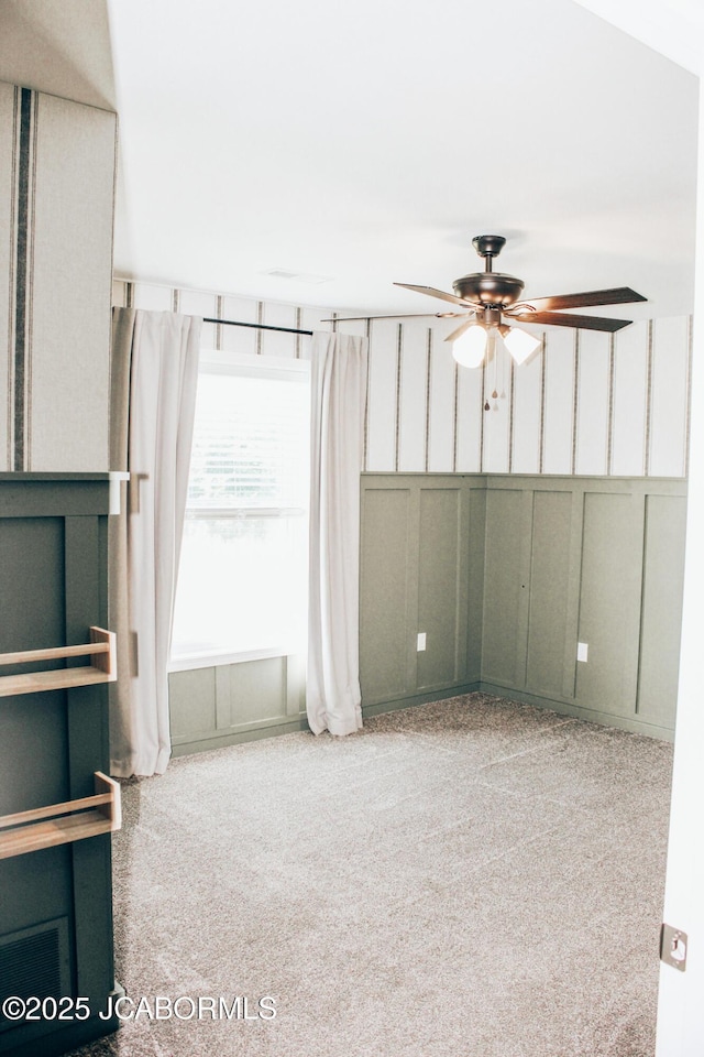 138 Stonegate Ave, Linn, MO 65051 - carpeted empty room featuring a decorative wall and ceiling fan