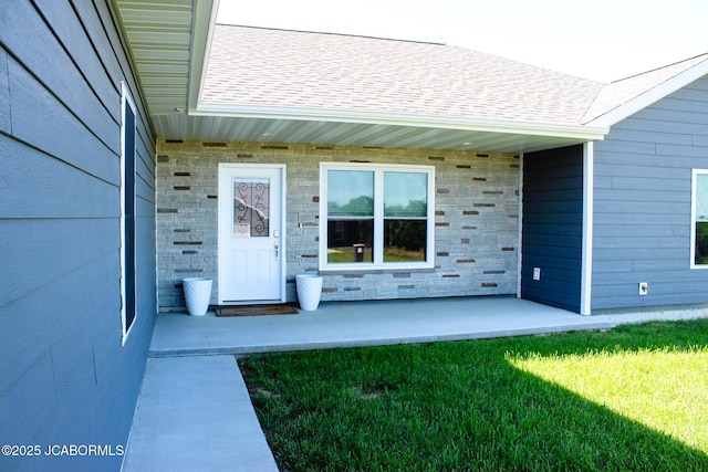 138 Stonegate Ave, Linn, MO 65051 - doorway to property featuring stone siding, roof with shingles, and a lawn