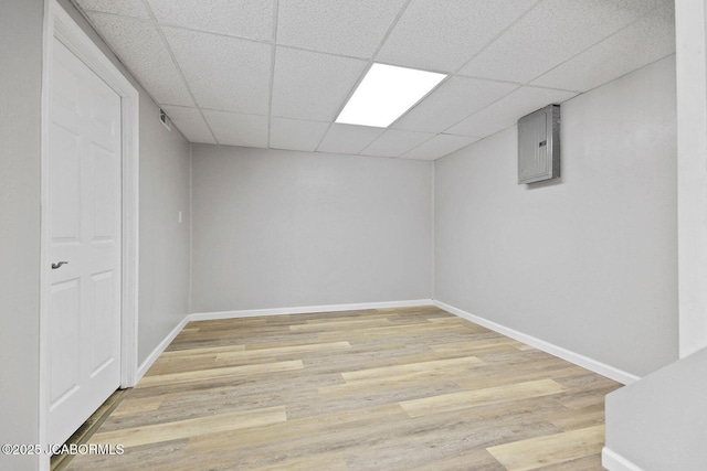 1906 Swifts Hwy, Jefferson City, MO 65109 - finished below grade area featuring light wood-style floors, electric panel, a paneled ceiling, and baseboards