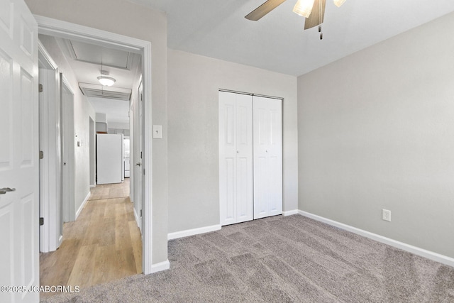 1906 Swifts Hwy, Jefferson City, MO 65109 - unfurnished bedroom with attic access, freestanding refrigerator, baseboards, a closet, and light carpet