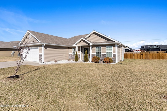 view of front of house featuring stone siding, fence, concrete driveway, an attached garage, and a front yard