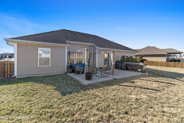 rear view of house with a yard, a patio, a fenced backyard, and a shingled roof