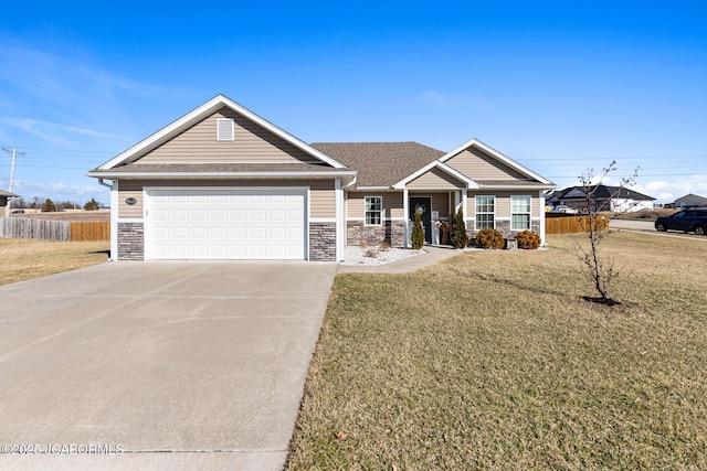 craftsman-style home with stone siding, concrete driveway, a front lawn, and fence