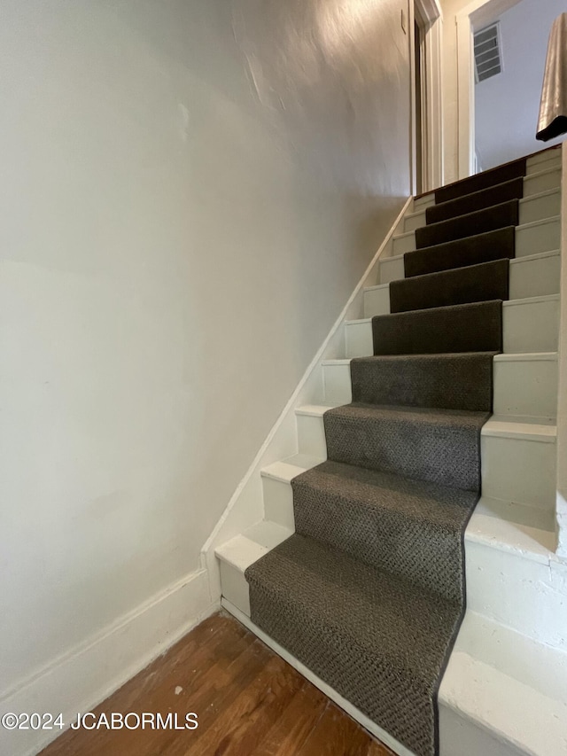 stairway featuring hardwood / wood-style floors