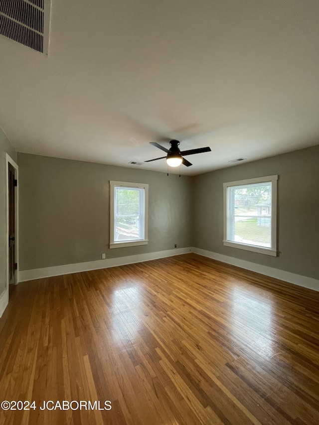 unfurnished room with hardwood / wood-style floors and ceiling fan