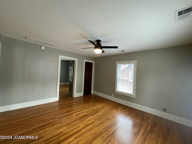 spare room featuring ceiling fan and hardwood / wood-style flooring