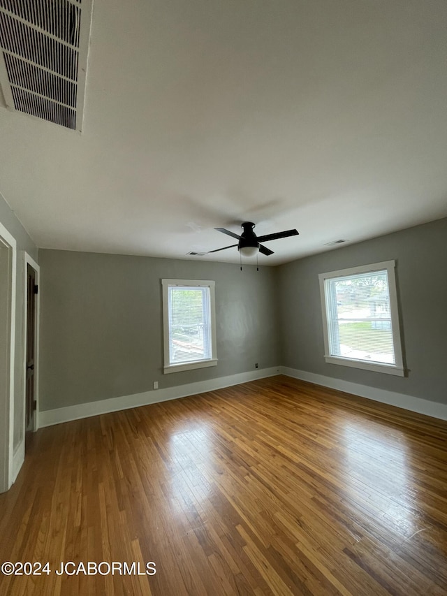 unfurnished room featuring ceiling fan and hardwood / wood-style floors