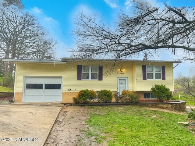 bi-level home with an attached garage, driveway, a front yard, and brick siding