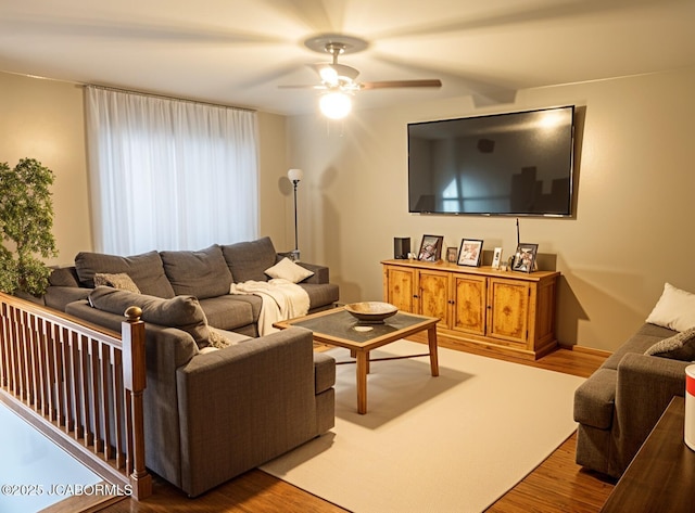 living room featuring wood finished floors and a ceiling fan