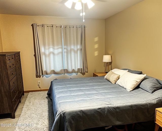 bedroom featuring baseboards and a ceiling fan