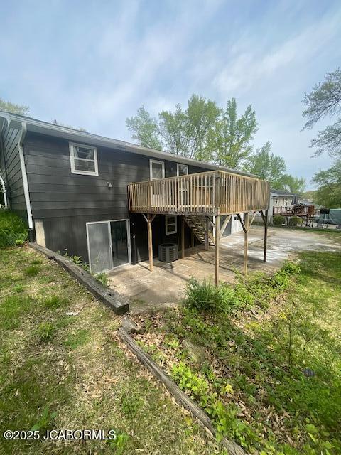 rear view of house featuring stairway, a wooden deck, central AC unit, and a patio