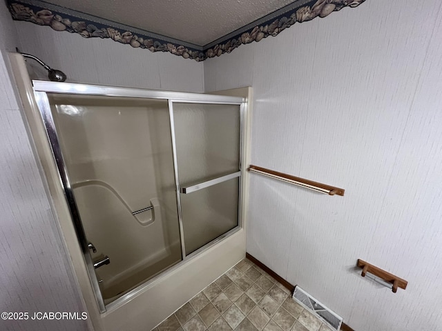 2362 County Road 4032, Holts Summit, MO 65043 - bathroom featuring bath / shower combo with glass door and a textured ceiling