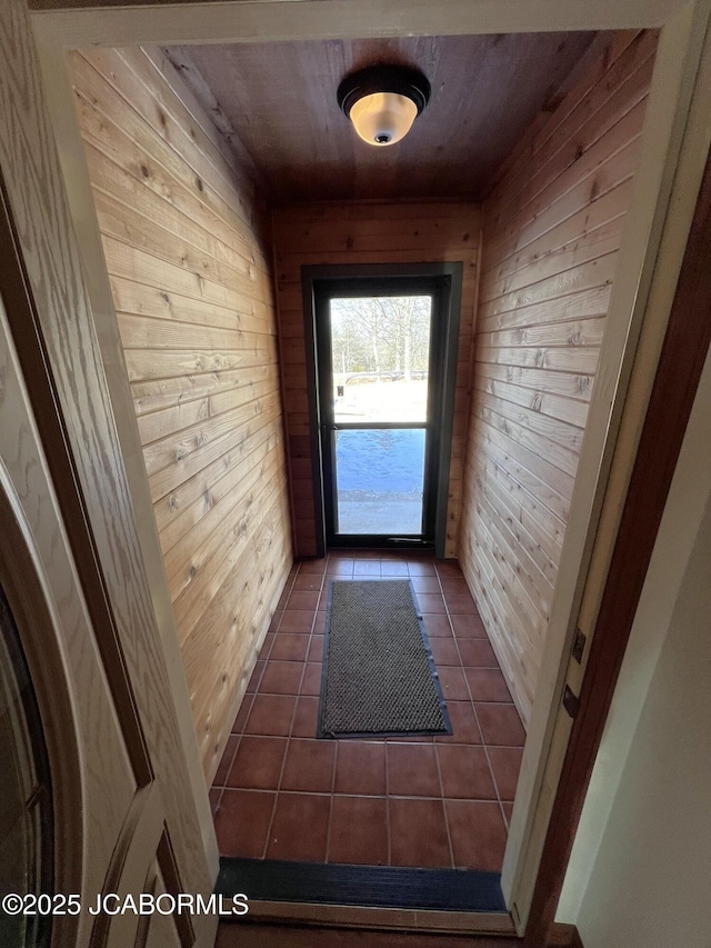2362 County Road 4032, Holts Summit, MO 65043 - doorway featuring wooden walls, dark tile patterned flooring, and wooden ceiling