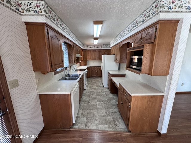 2362 County Road 4032, Holts Summit, MO 65043 - kitchen with decorative backsplash, white appliances, sink, and a textured ceiling