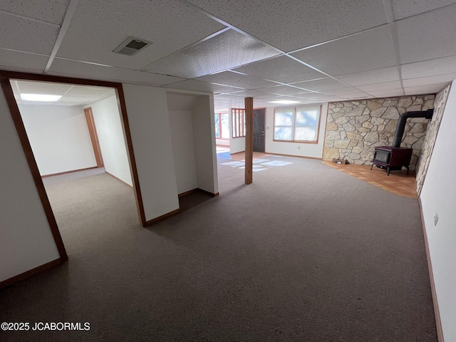 2362 County Road 4032, Holts Summit, MO 65043 - basement featuring carpet floors, a wood stove, and a paneled ceiling