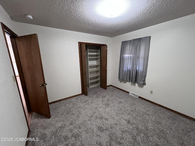 2362 County Road 4032, Holts Summit, MO 65043 - unfurnished bedroom featuring carpet floors, a textured ceiling, and a closet