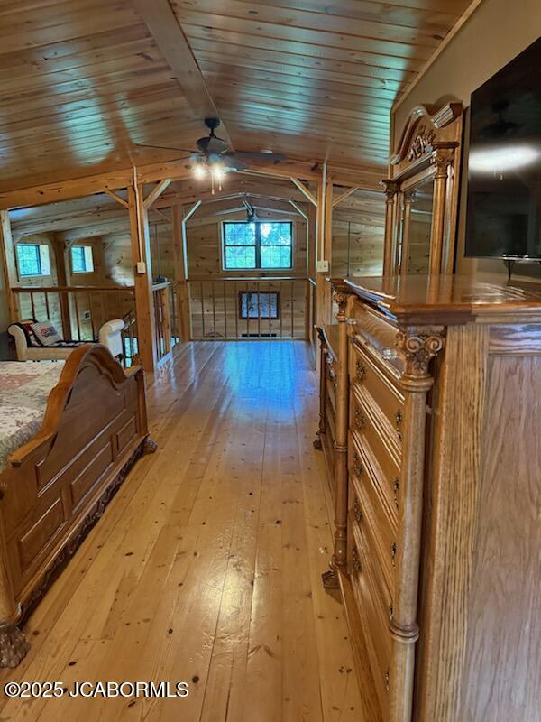 11 Copperhead Rd, Eldon, MO 65026 - bedroom featuring light wood-style flooring, wood walls, wooden ceiling, and lofted ceiling