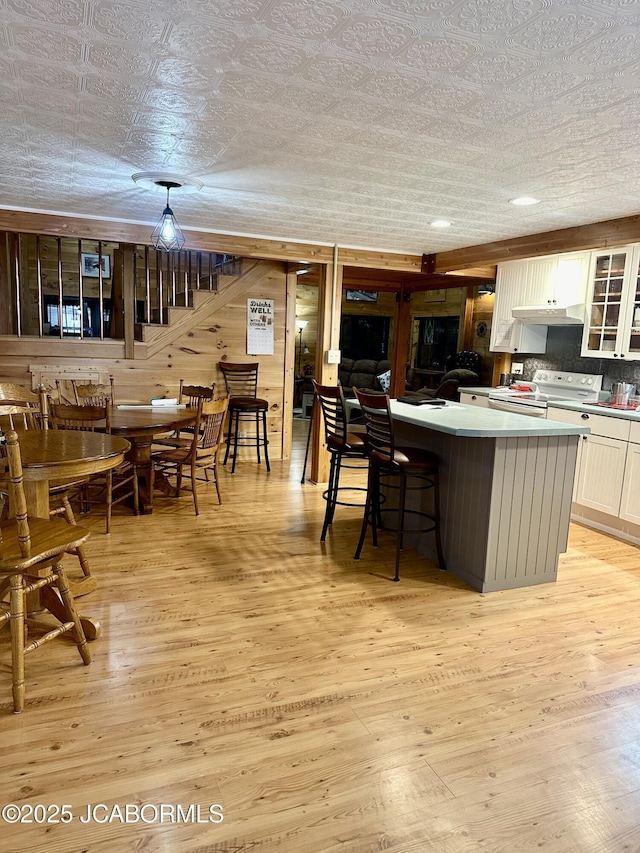 11 Copperhead Rd, Eldon, MO 65026 - kitchen featuring white electric stove, white cabinets, light wood-style flooring, and glass insert cabinets