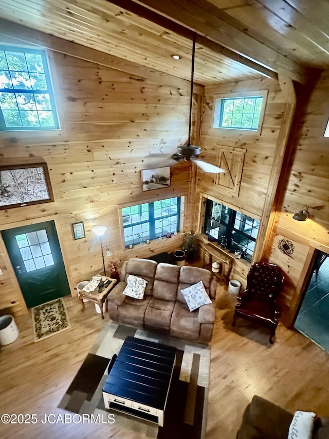 11 Copperhead Rd, Eldon, MO 65026 - living room with wood walls, wood finished floors, a towering ceiling, and a wood ceiling with exposed beams