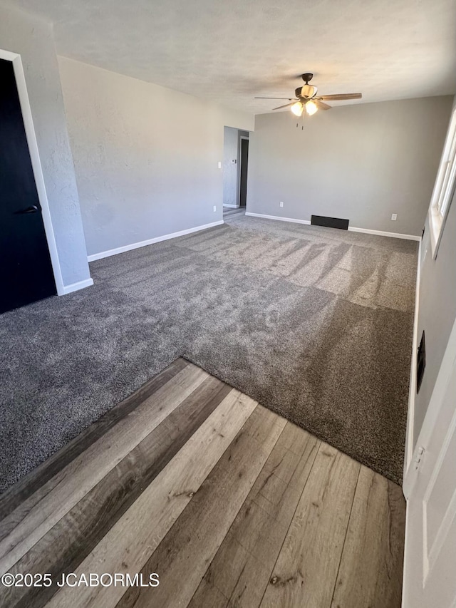 unfurnished living room with hardwood / wood-style flooring and ceiling fan