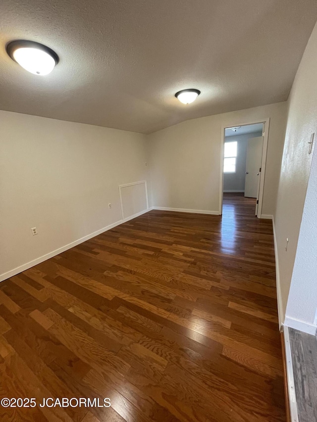 106 S Main St, Chamois, MO 65024 - spare room with dark wood-style floors, baseboards, and a textured ceiling
