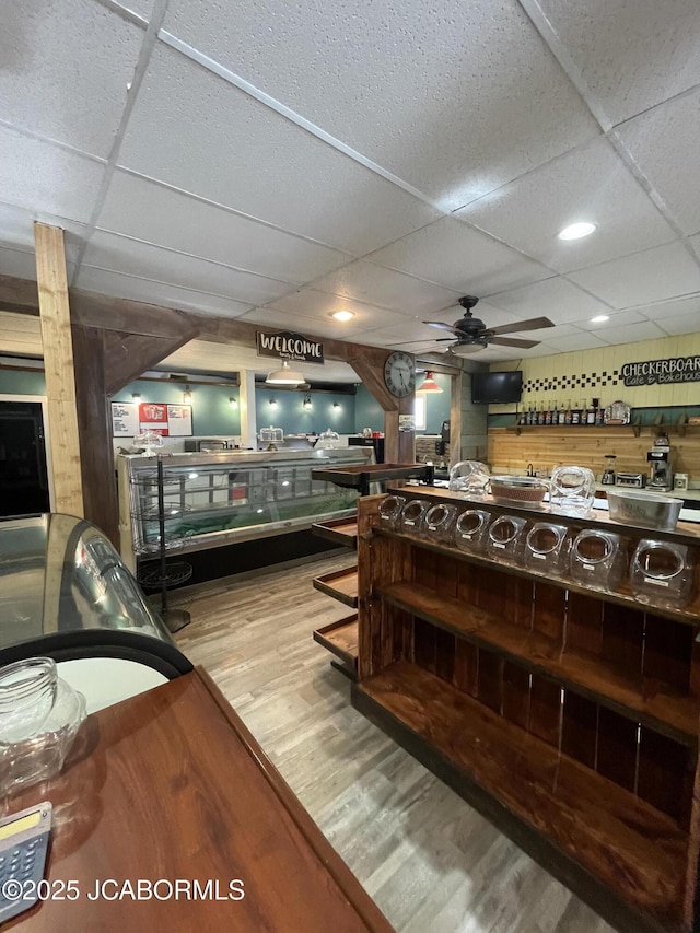 106 S Main St, Chamois, MO 65024 - misc room with a paneled ceiling, ceiling fan, wood finished floors, and wood walls