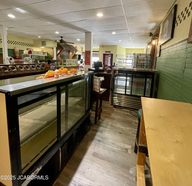 106 S Main St, Chamois, MO 65024 - indoor dry bar with a paneled ceiling, wood finished floors, and a ceiling fan