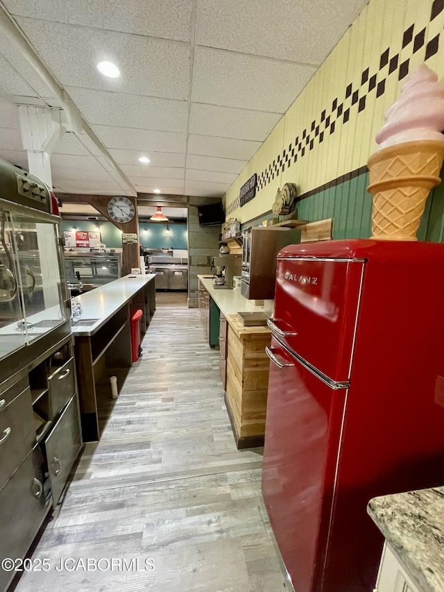 106 S Main St, Chamois, MO 65024 - kitchen with freestanding refrigerator, light wood-type flooring, a drop ceiling, light countertops, and recessed lighting