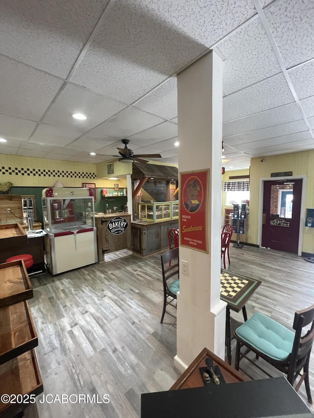 106 S Main St, Chamois, MO 65024 - dining area featuring a drop ceiling, a ceiling fan, and wood finished floors