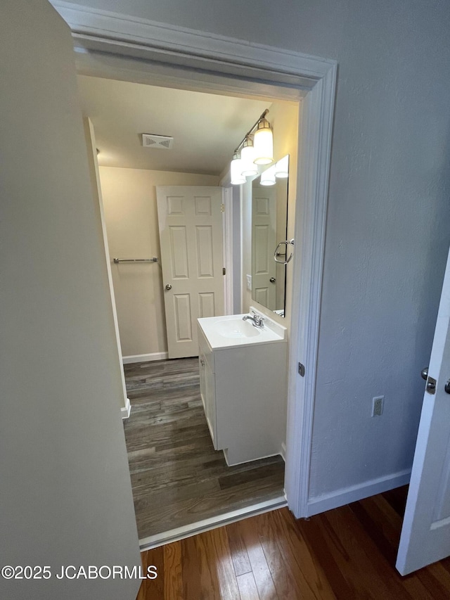 106 S Main St, Chamois, MO 65024 - bathroom featuring wood finished floors, baseboards, and vanity