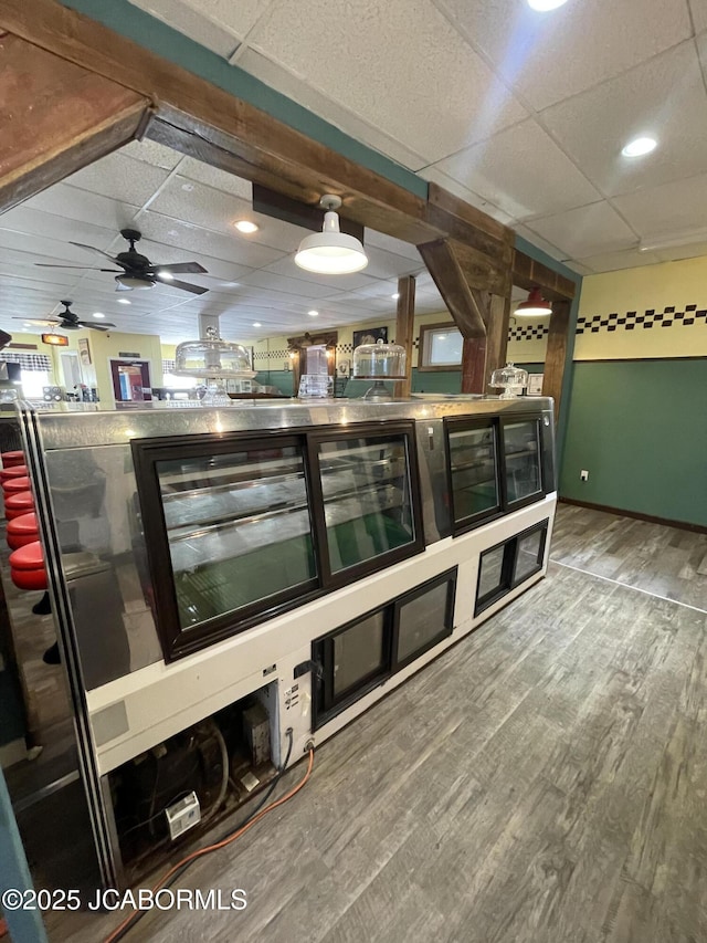 106 S Main St, Chamois, MO 65024 - bar with wood finished floors, a drop ceiling, a ceiling fan, and baseboards